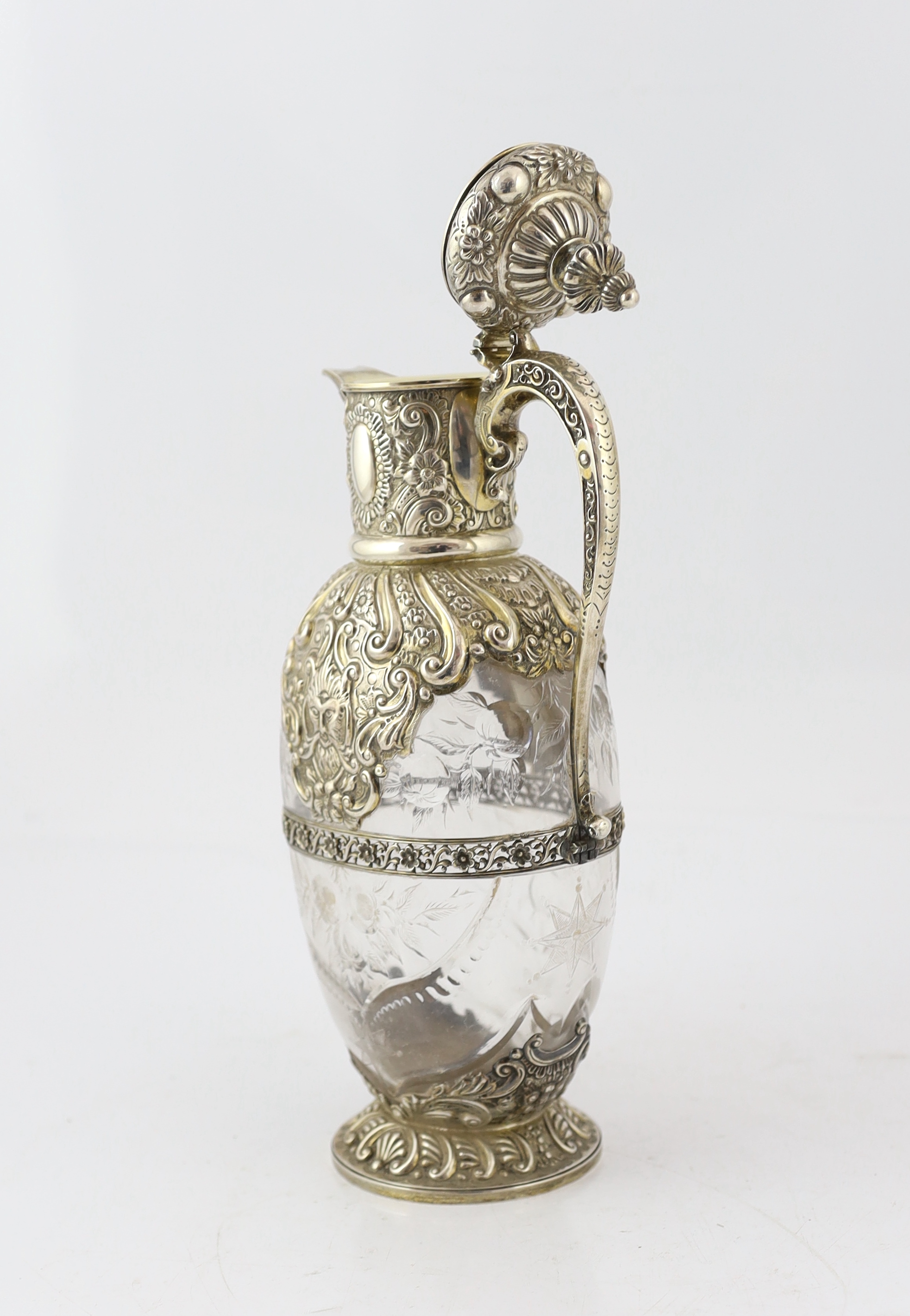 An ornate late Victorian silver mounted cut glass claret jug, by Charles Edwards